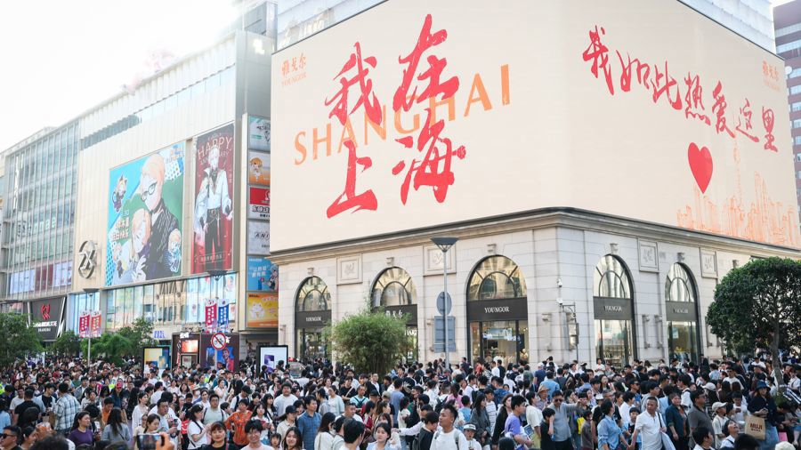 “五一”小長假南京路步行街游人如織、消費(fèi)火熱。一塊戶外大屏打出中文、英文等多種語言的“我在上海，我如此熱愛這里”暖心話語，歡迎世界各地游客。記者 海沙爾 攝.jpg
